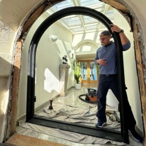 img of an iron door being installed